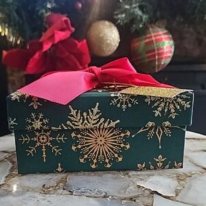 Festive Green and Gold Gift Box with Red Ribbon